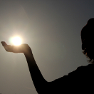 Child Holding Sun in his Hand